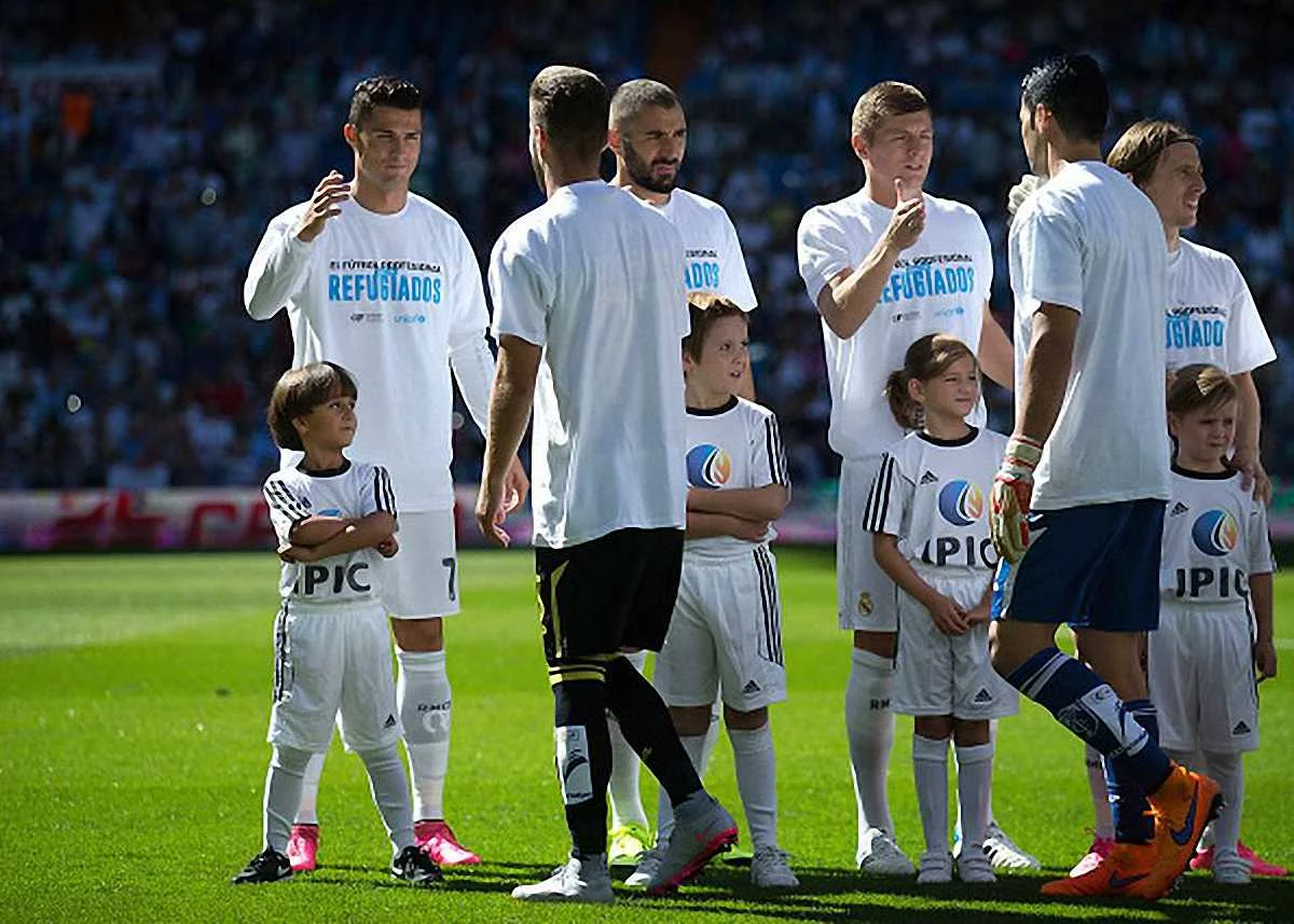 Роналду и маленький беженец / Getty Images